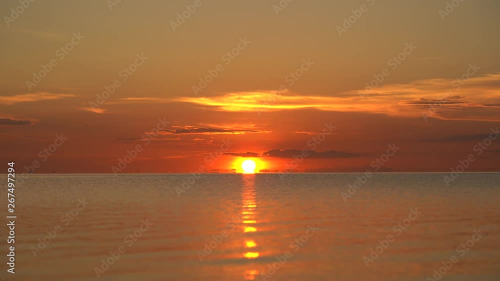 Colorful sunset over calm sea water near tropical beach. Summer vacation concept. Island Koh Phangan, Thailand Colorful sunset over calm sea water near tropical beach. Summer vacation concept. Island Koh Phangan, Thailand