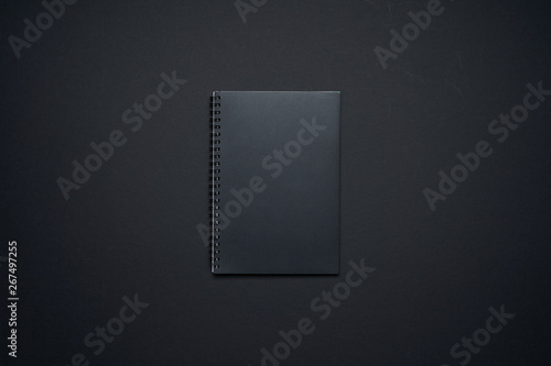 Black note book template isolated on black background for your design
