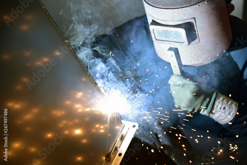Arc welding work at a back street factory in Japan: Welding while protecting with handle welding mask