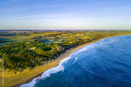 Ocean coastline and countryside at sunset - aerial landscape