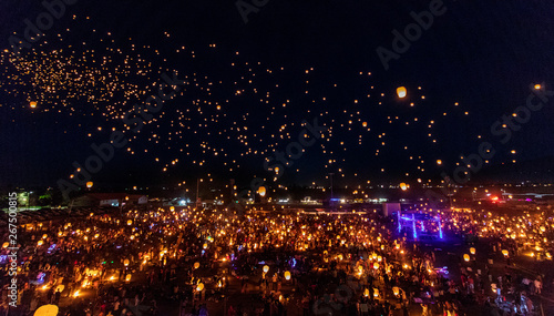 Flying lantern light festival with thousands of people and lanterns.