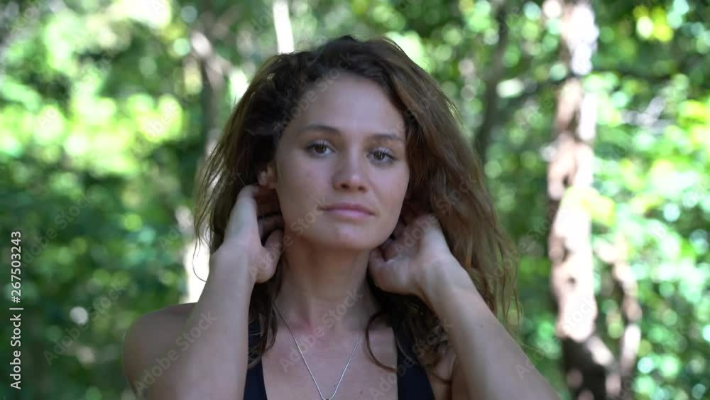 Portrait of a young caucasian brunette girl on nature, at tropical garden in summer, Thailand, close up Portrait of a young caucasian brunette girl on nature, at tropical garden in summer, Thailand, close up