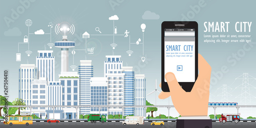 Smart city on urban landscape with hand holding smartphone.