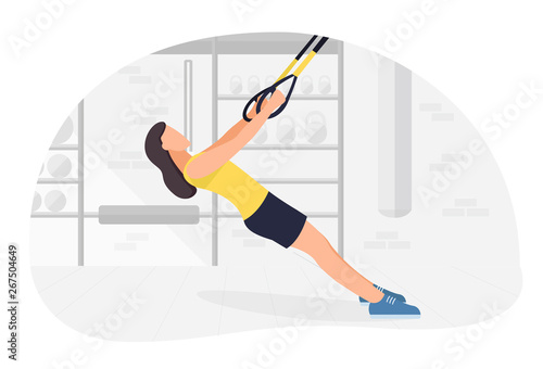 Fit woman working out on trx doing bodyweight exercises. Fitness strength training workout.