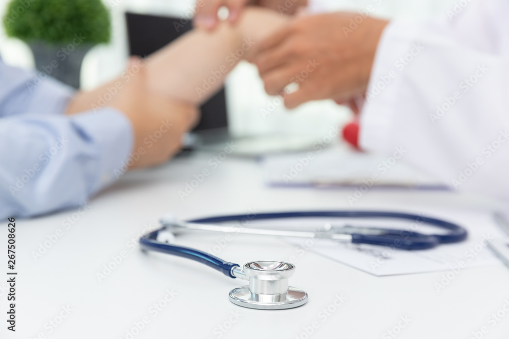 Healthcare and medical concept, Doctor explain wrist pain symptoms and medical treatment to patient in hospital