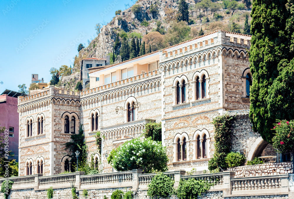 Facade wall of old baroque palace building in Taormina, traditional architecture of Sicily, Italy.