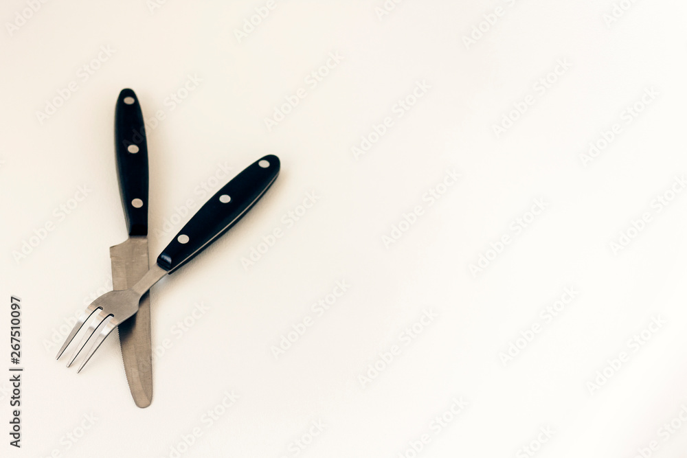 Close up knife and fork crossed, isolated on white background. Close up knife and fork crossed, isolated on white background.