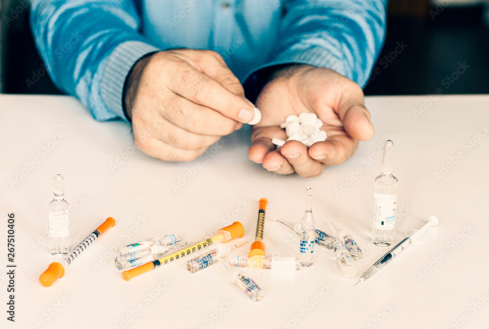 Medicine pills or capsules with man’s hands on white background with copy space. Medicine pills or capsules with man’s hands on white background with copy space.