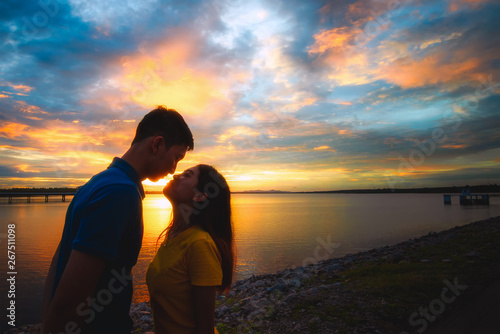 Couple in love at lake during beautiful sunset.relaxing concept.