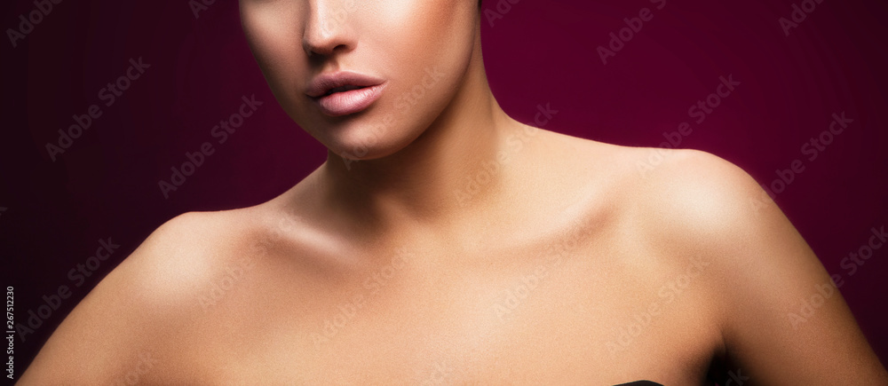 Lips, part of face, shoulders of young woman with perfect skin, nude makeup. Dark red background Lips, part of face, shoulders of young woman with perfect skin, nude makeup. Dark red background