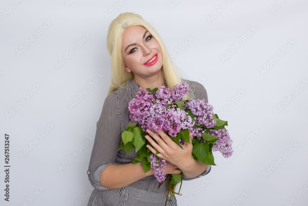 Blonde woman holding lilac flowers Blonde woman holding lilac flowers