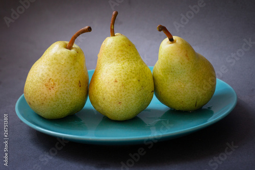 Group of yellow pears on blue plate