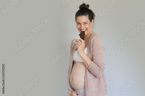 Canvas Print Pregnant woman craving for chocolate bar, isolated