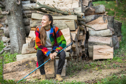 Spring or autumn travel woman with trekking poles resting photo