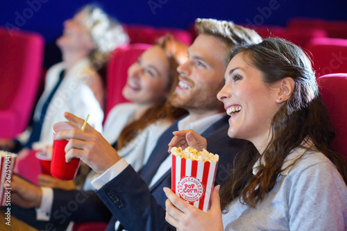 cute couple in cinema watching movie