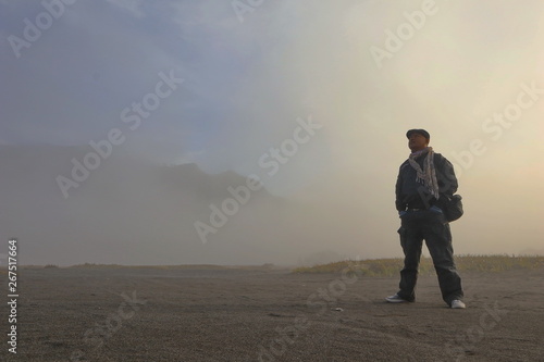 The atmosphere of the Bromo mountains in the morning, which is cold and foggy. © onyengradar
