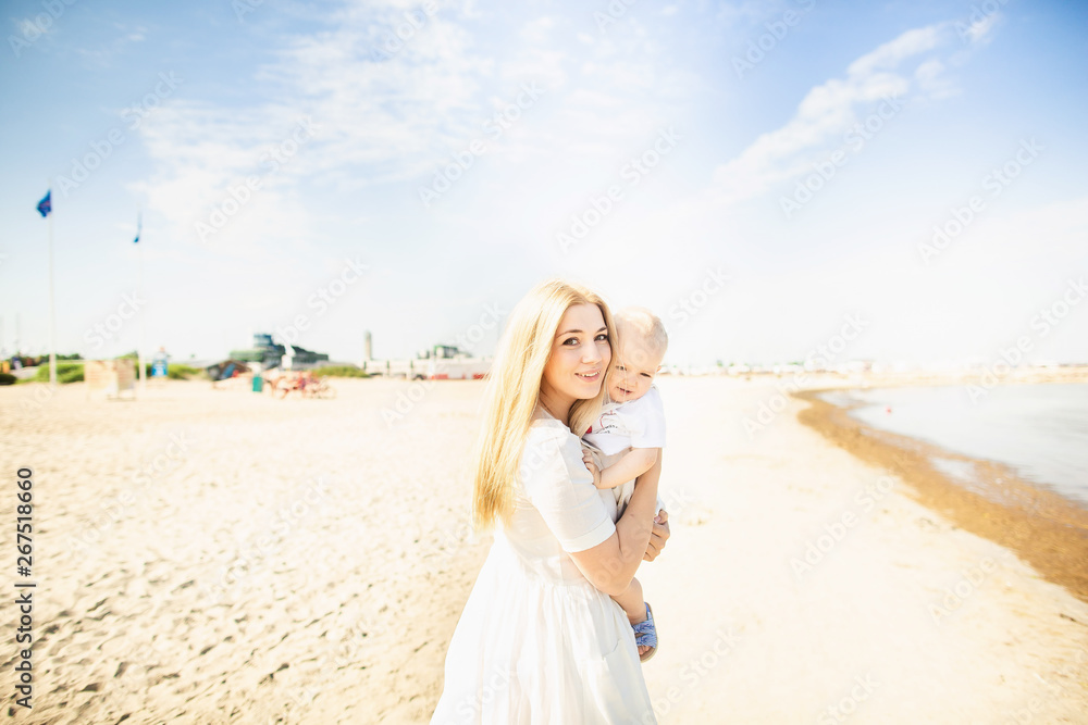 Happy mother huges baby. Mother holds child in her arms, baby hugging mom Happy mother huges baby. Mother holds child in her arms, baby hugging mom