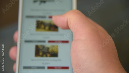 A man looking and chooses a weapons to buy on the site.