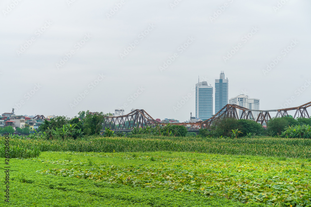 Long Bien ancient metal bridge viewing from farming field in Hanoi, Vietnam
