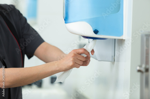 hands usings a tissue dispenser photo