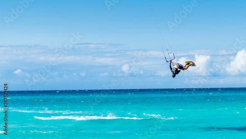 Varadero, Cuba. Kitesurfer jumping in the beach of Varadero in Cuba on a warm sunny day with fluffy clouds.