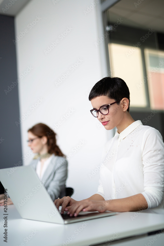 Business colleagues in conference meeting room during presentation Business colleagues in conference meeting room during presentation