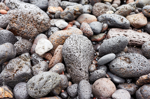 Natural background made of pebbles and volcanic rocks  selective focus.