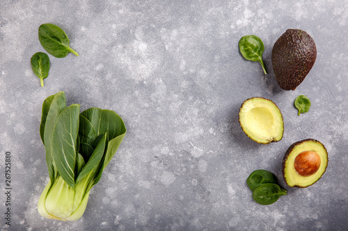 Photography Hass avocados, spinach leaves, bok choy (pak choy, chinese cabbage) on gray background