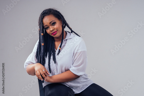 Valokuva africa american woman with long black pigtails dreadlocks in studio on white bac