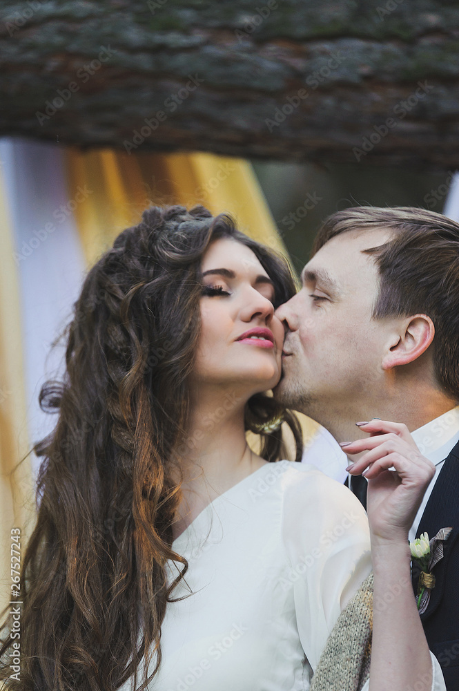 Portrait  of wedding couple in rustic style in love in the  wood posing in sunbeams