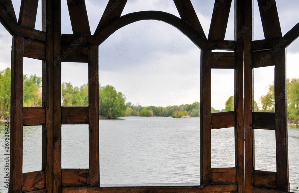 wooden gazebo on the river bank