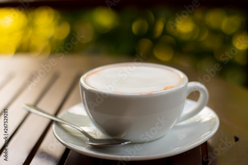 Cup of tea on wooden table on bokeh background. 