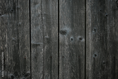 Dark gray shabby boards. Old dark grey fence with hobnail. Antique wooden table. Retro gray wood surface. Old wooden texture background. Dirty parquet.