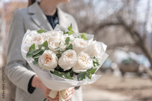 Mono bouquet of garden roses. Delicate bouquet of mixed flowers in womans hands. the work of the florist at a flower shop. Delicate Pastel color. Fresh cut flower.
