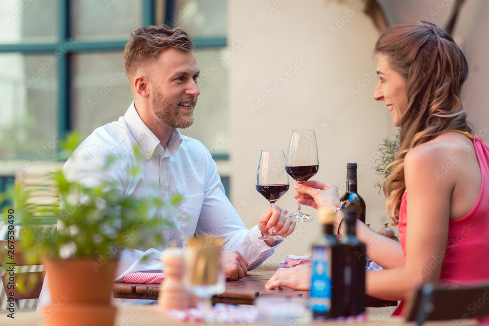 Happy couple having red wine