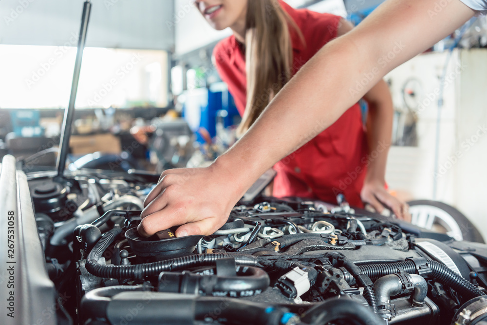 Hand of an auto mechanic checking the car of a customer Hand of an auto mechanic checking the car of a customer