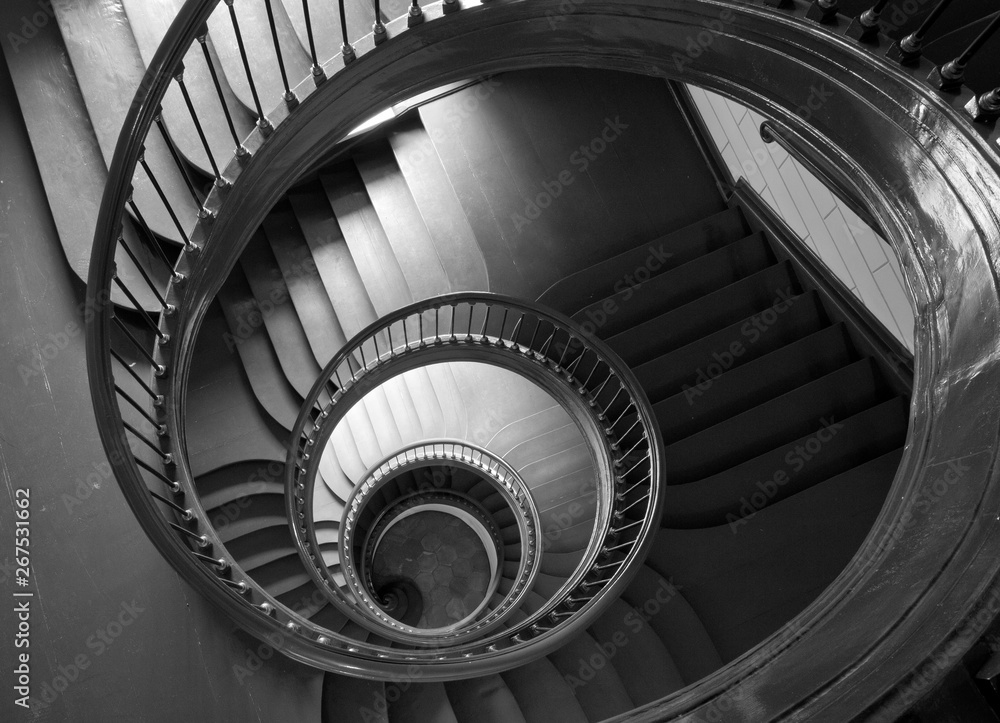 Antique spiral staircase in black and white.