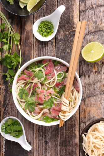 broth with noodles, beef and coriander