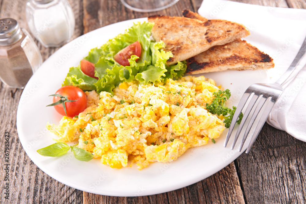 scrambled egg with bread toast and salad