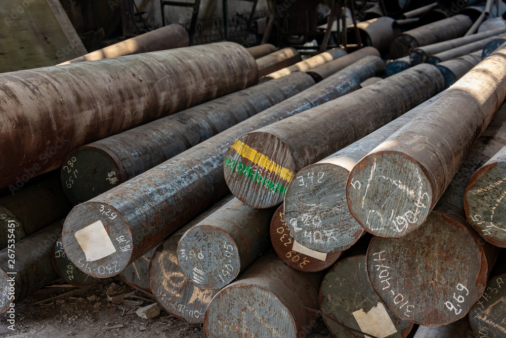 Metal rolling. A round tube are stacked in storage for sale and loading in stock. View from the front, end view, close-up.