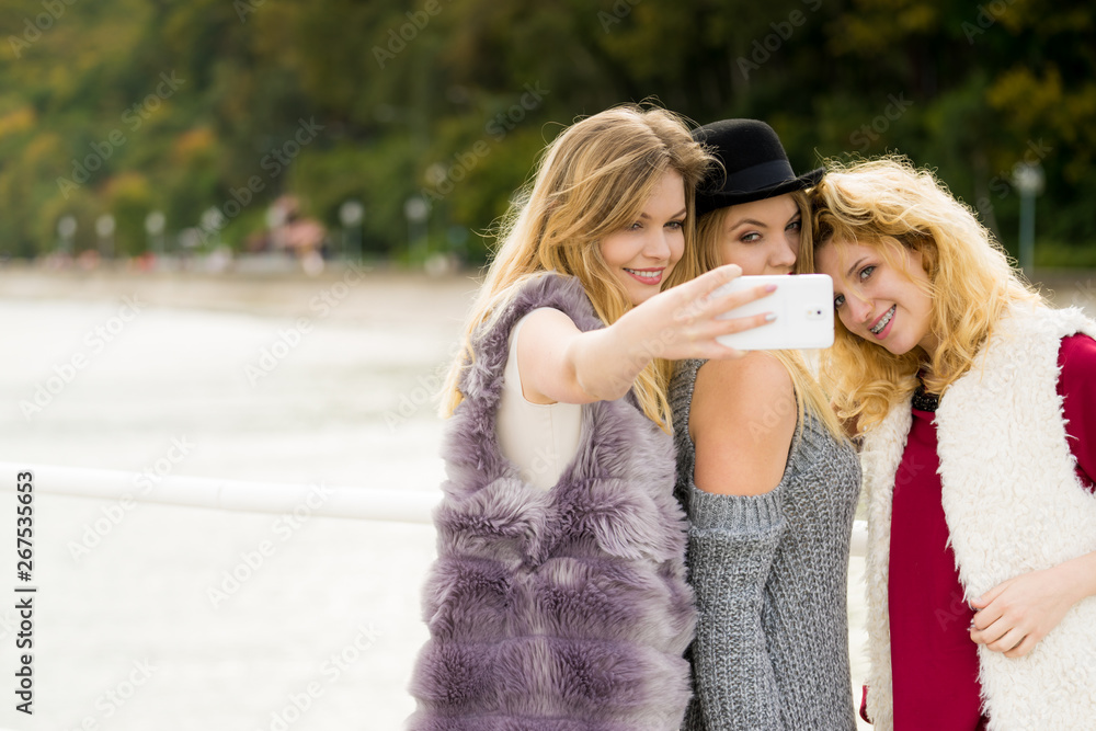 Fototapeta premium Three women taking selfie outdoor