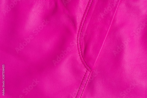 Pink leather skirt. Stitched placket closeup texture.