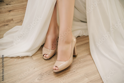 beautiful legs of a girl in a white wedding dress © Olha Cheverda