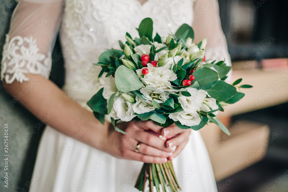 wedding bouquet with a variety of fresh flowers in the hands of a young bride wedding bouquet with a variety of fresh flowers in the hands of a young bride