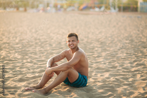 Portrait of an attractive young man on a tropical beach. Handsome man on the coast