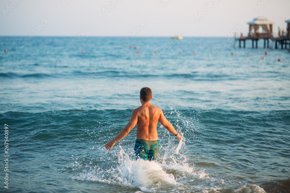 Man splash sea water in the sea
