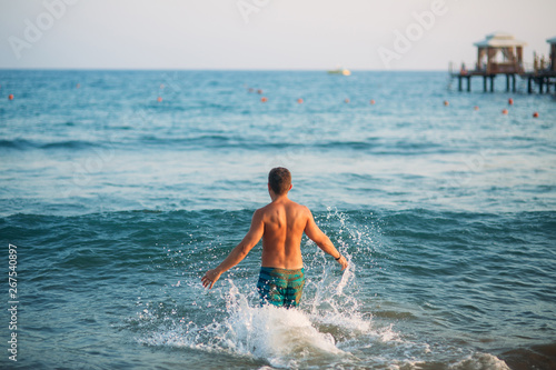 Man splash sea water in the sea