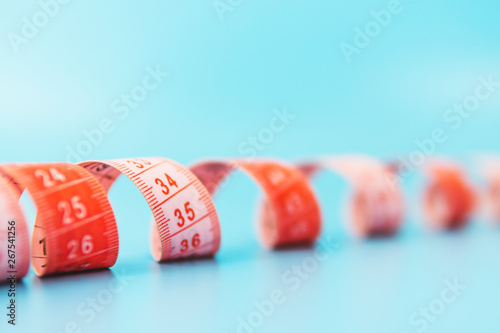 red measuring tape on a blue background