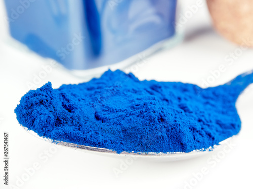 Blue Spirulina powder, isolated on white photo