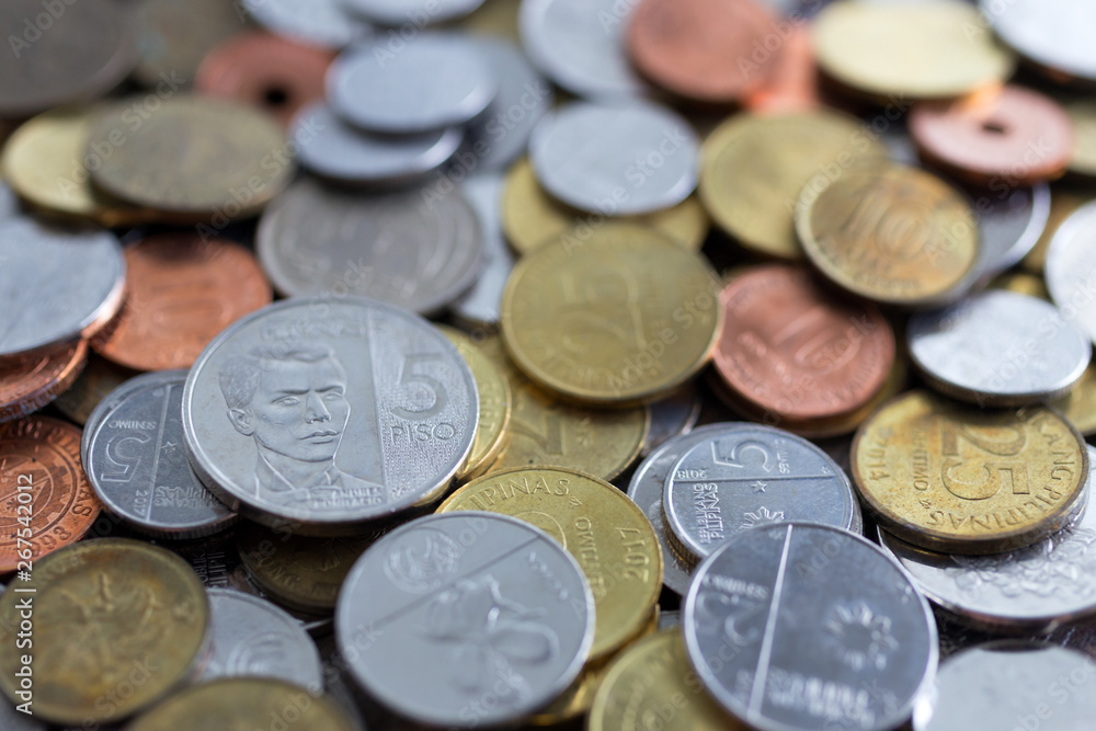 A pile of new and old Philippines peso coins A pile of new and old Philippines peso coins